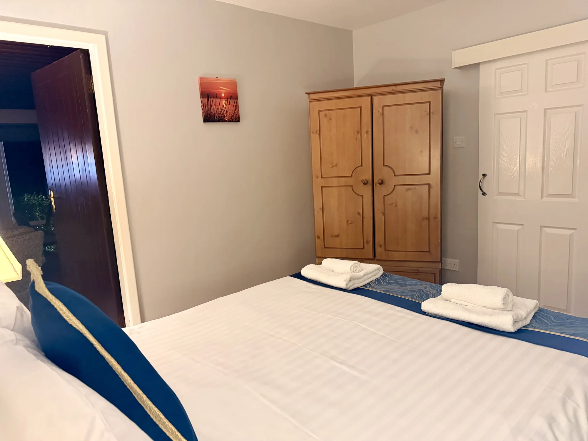 Double bedroom and wooden wardrobe at Dolphin House