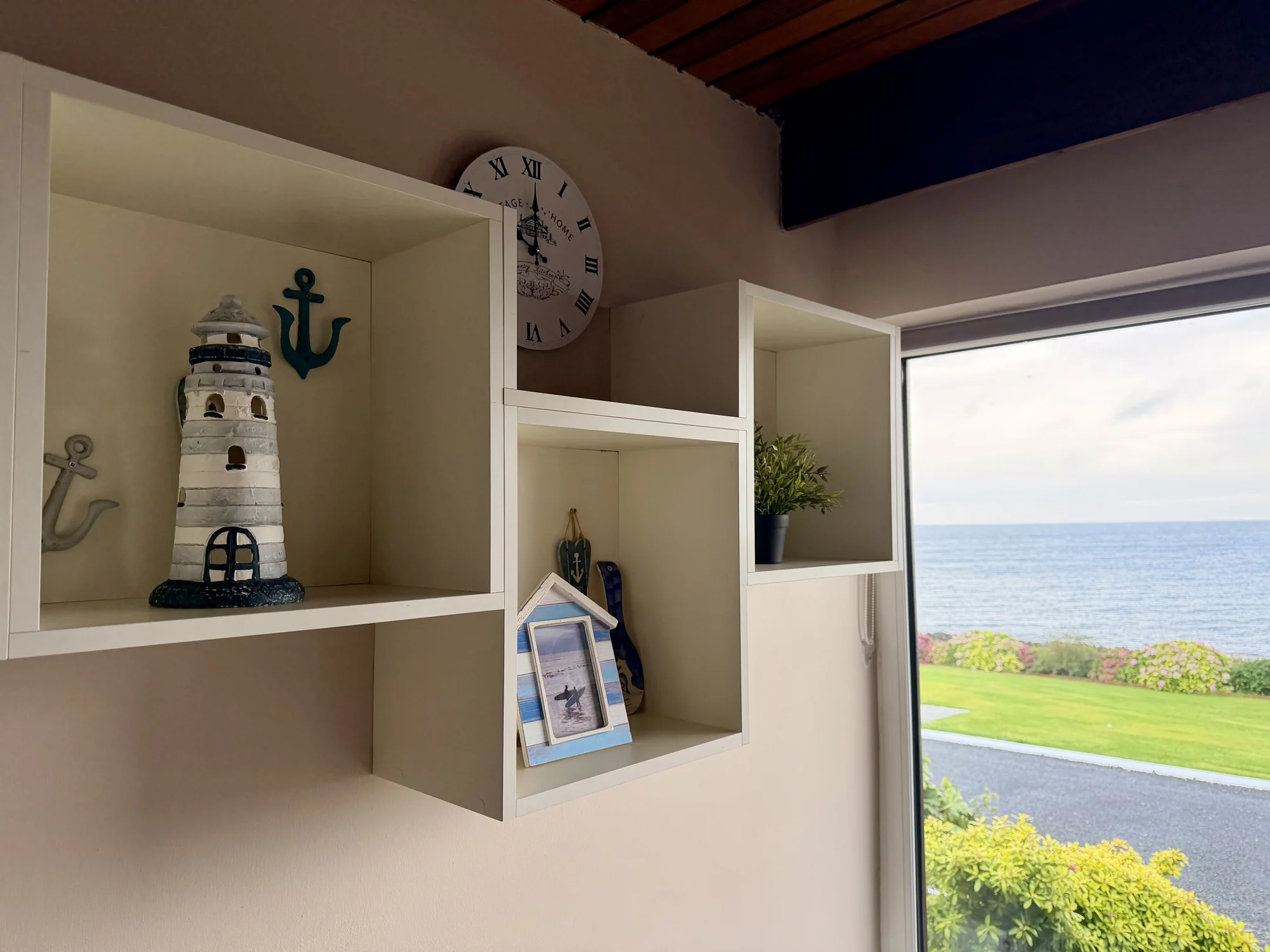 Nautical ornaments beside a sea-view window at Dolphin House