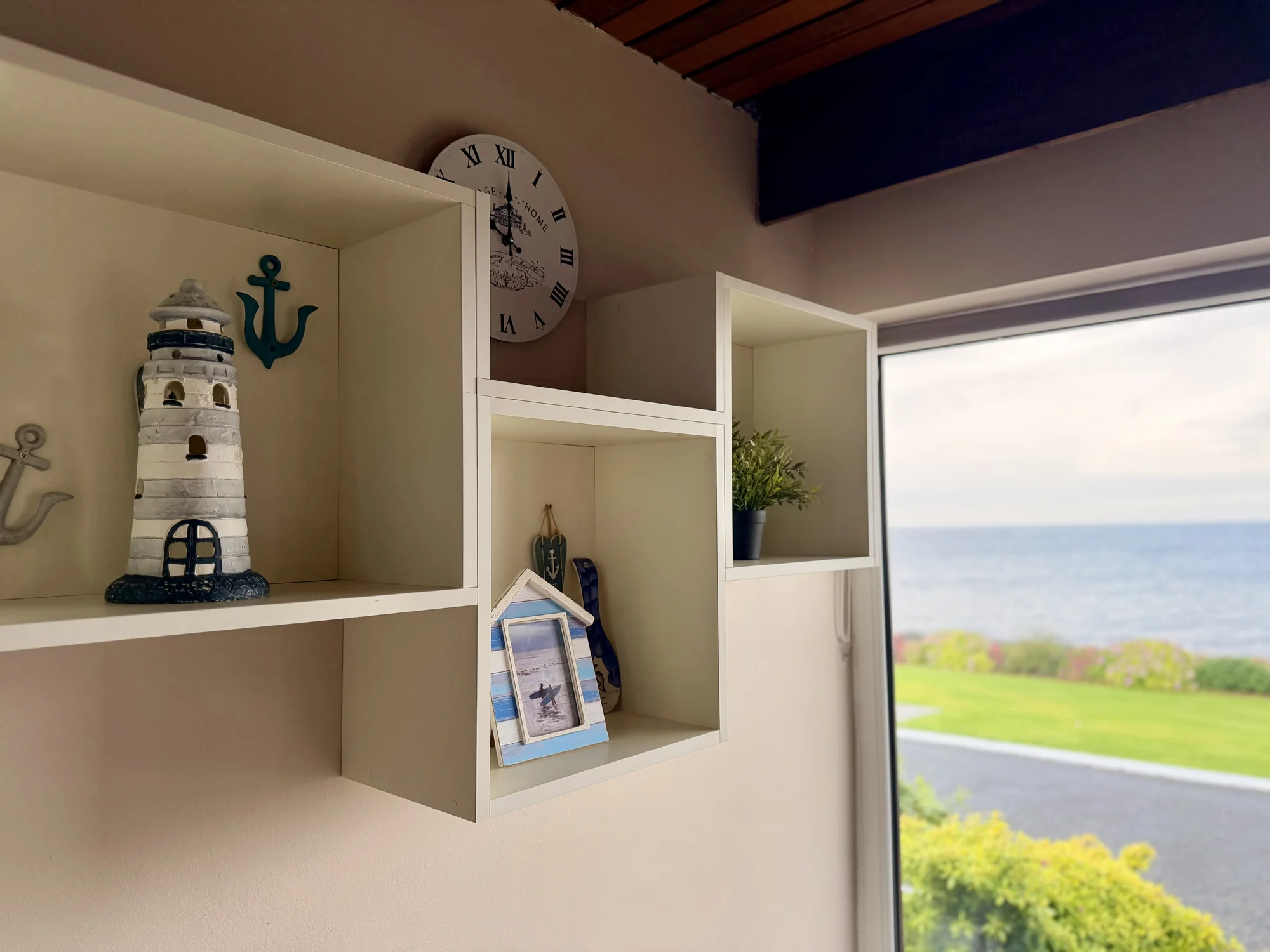 Decorative lighthouse and shelving beside the garden view at Dolphin House